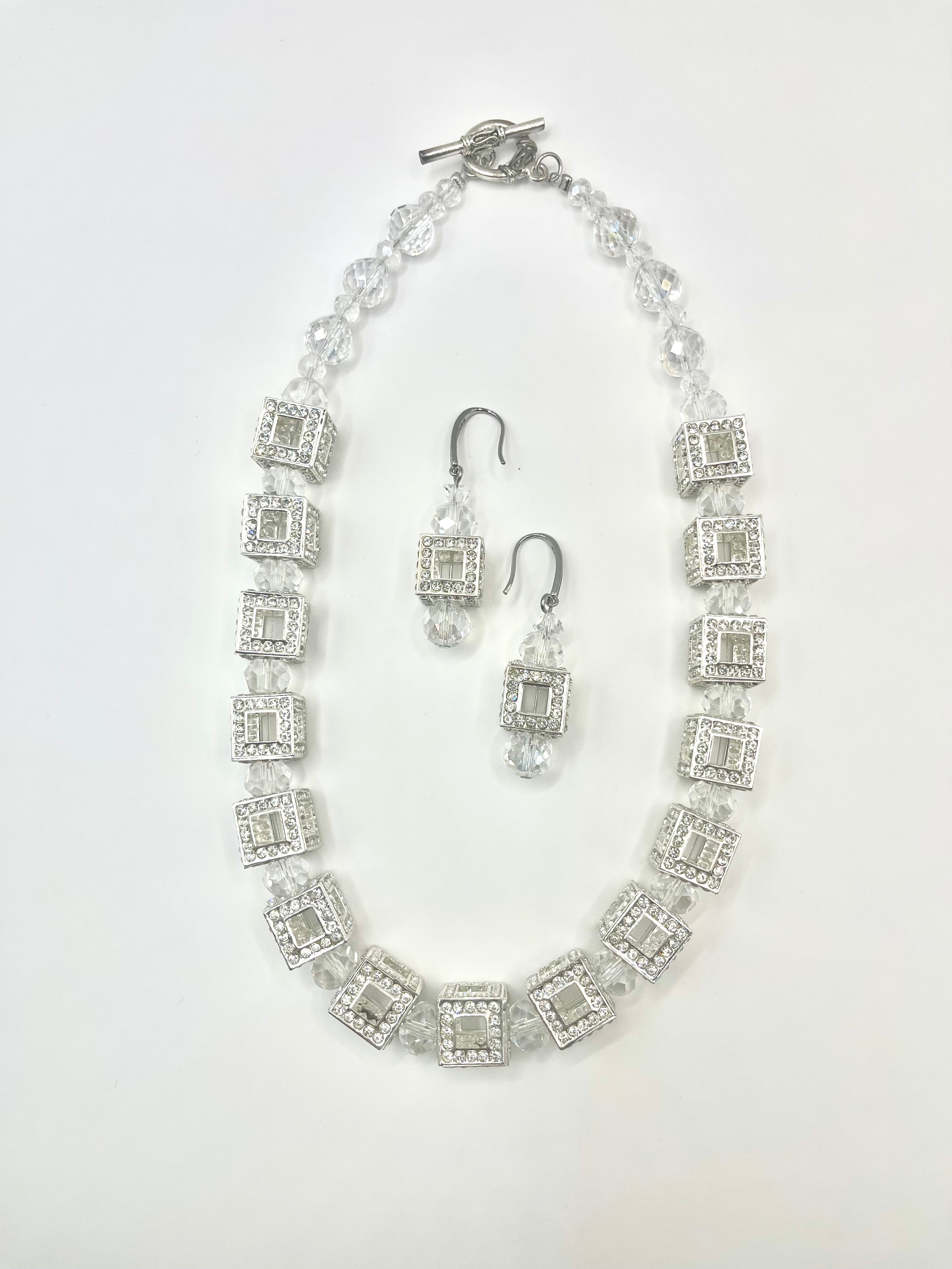 A Jet Crystal Beads Necklace with silver crystal rondell stations, cubed in shape, on a white background.