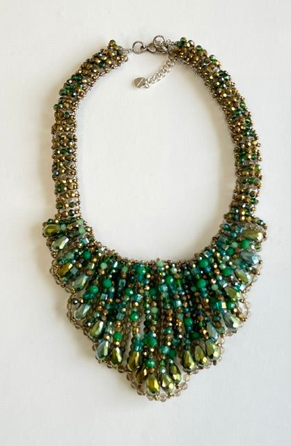 Green beaded necklace on a white background