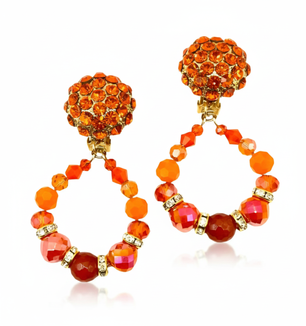 Pair of orange beaded earrings on a white background
